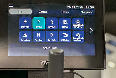 Close-up of a PARAVAN touchscreen in a vehicle displaying various driving and control functions.
