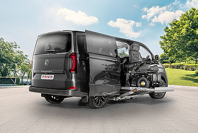 A close-up of the rear of a VW New Caravelle, clearly showing the “Caravelle” lettering and a Paravan logo in the license plate holder. The sun is shining, causing a building to be reflected in the car.