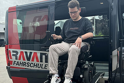 Wheelchair user entering a PARAVAN driving school vehicle via ramp for driver training with disabilities.
