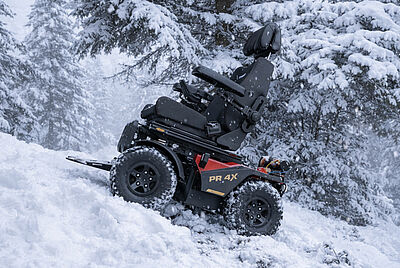 PARAVAN PR 4X electric wheelchair in off-road terrain – all-terrain wheelchair driving in snow for maximum mobility.