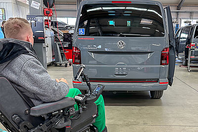 Philip with his wheelchair in front of the rear of his new silver VW T6.1