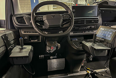 View of the cockpit in an accessibility-modified vehicle featuring joystick control, PARAVAN touchscreen, and Space Drive technology.