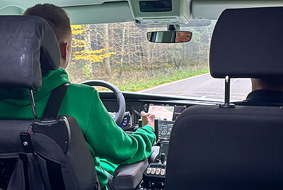 View from the back seat of Philip driving his new wheelchair-accessible vehicle