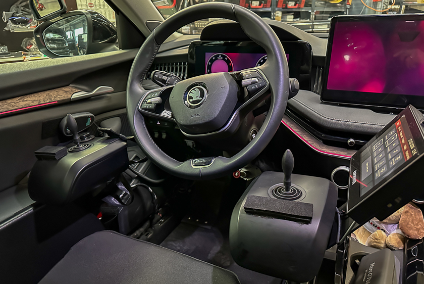 There is a joystick mounted on each side of the steering wheel. The right joystick also features a Paravan touchscreen display. 
