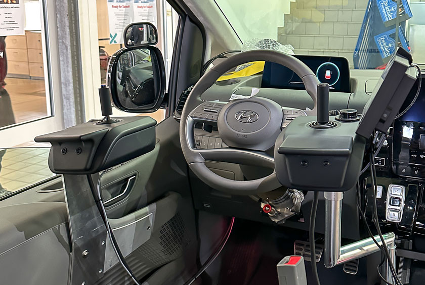 There are two joysticks mounted to the right and left of the steering wheel in the vehicle. The right joystick also features a Paravan Touch Display.