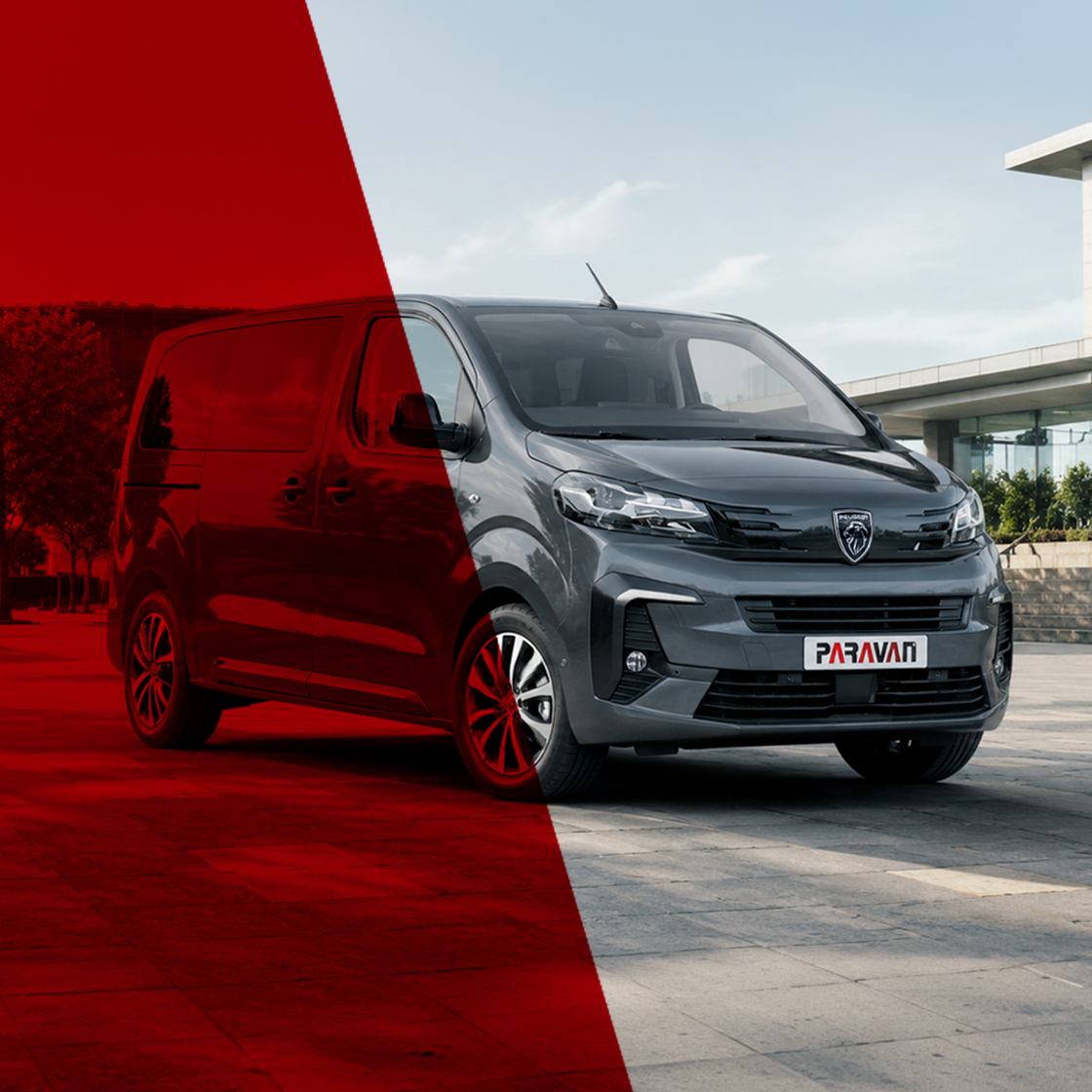 Black Peugeot Traveller stands on asphalt with modern buildings